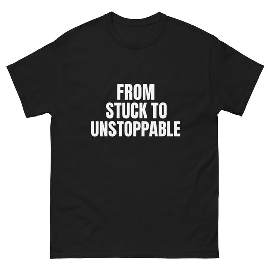 Black motivational T-shirt with white text: From Stuck to Unstoppable – OrnixMax mindset collection